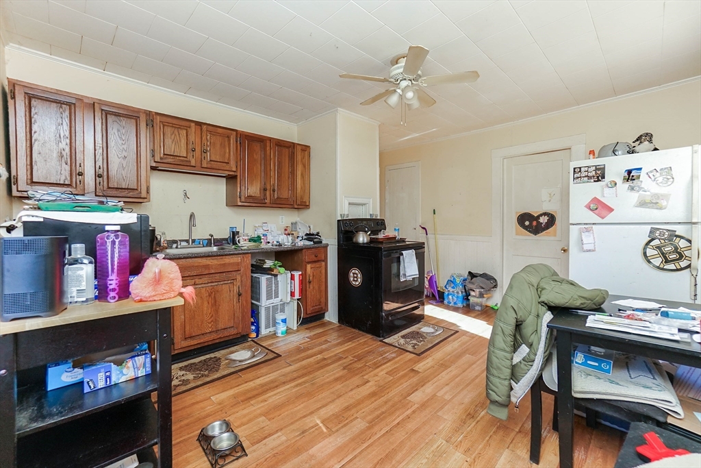 479 Main Street Hanson, MA 02341 - Photo 15 of 39 a open kitchen with stainless steel appliances granite countertop a stove refrigerator and a dining table with wooden floor