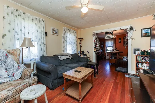 a living room with furniture and wooden floor