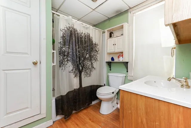 a bathroom with a sink toilet and shower