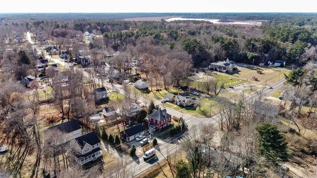 an aerial view of a house with a yard