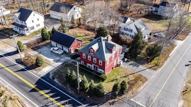 an aerial view of a house with garden space and street view