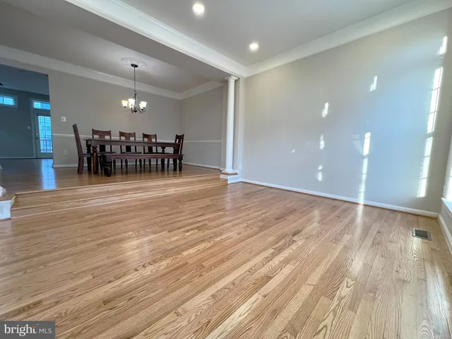 a view of a dining room with furniture and wooden floor