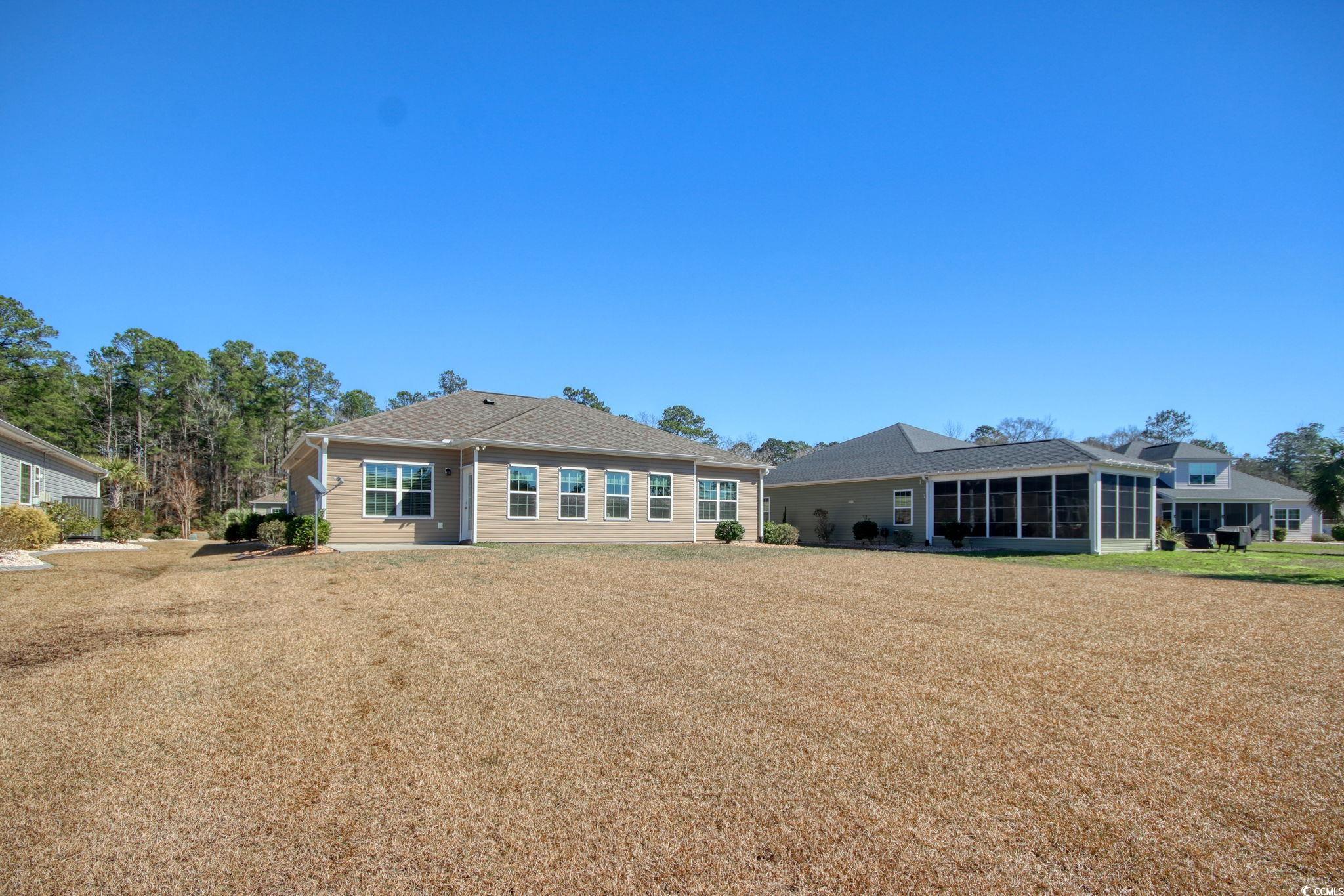434 Carrick Loop Longs, SC 29568 - Photo 33 of 39 Back of house featuring a sunroom and a lawn