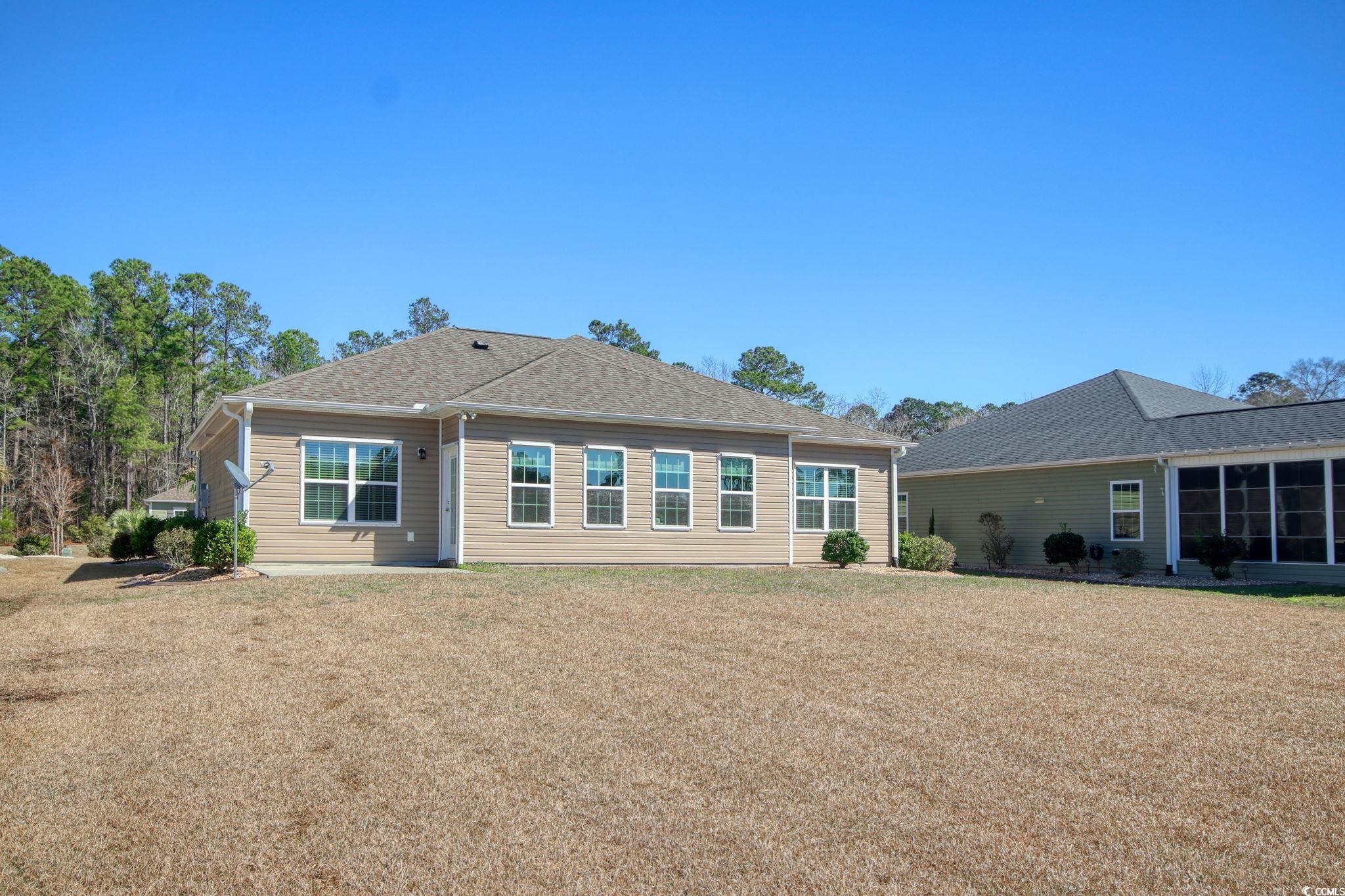 434 Carrick Loop Longs, SC 29568 - Photo 34 of 39 Rear view of property with a yard