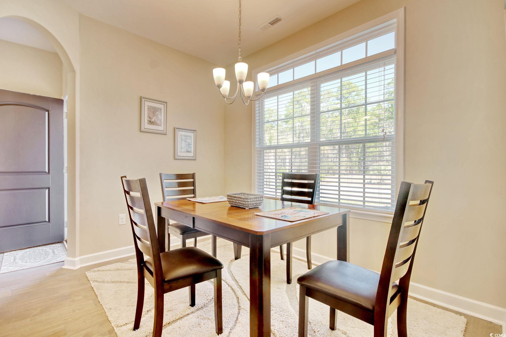 434 Carrick Loop Longs, SC 29568 - Photo 8 of 39 Dining room with a notable chandelier and light wo