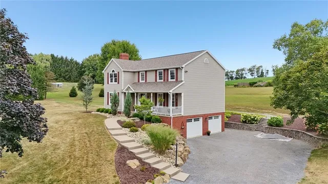 a front view of a house with garden