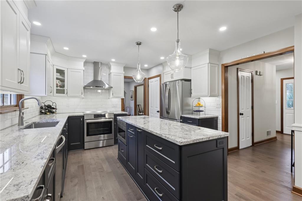 111 American School Road Harmony, PA 16037 - Photo 11 of 46 a large kitchen with granite countertop a large counter top a sink stainless steel appliances and cabinets