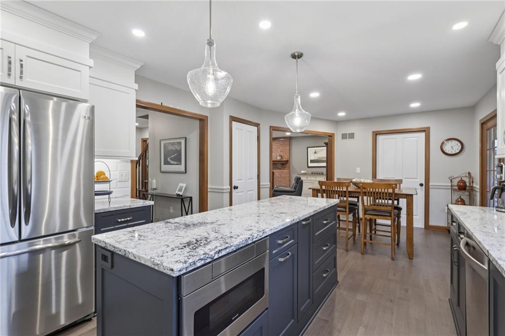 111 American School Road Harmony, PA 16037 - Photo 12 of 46 a kitchen with stainless steel appliances granite countertop a kitchen island a stove and a sink