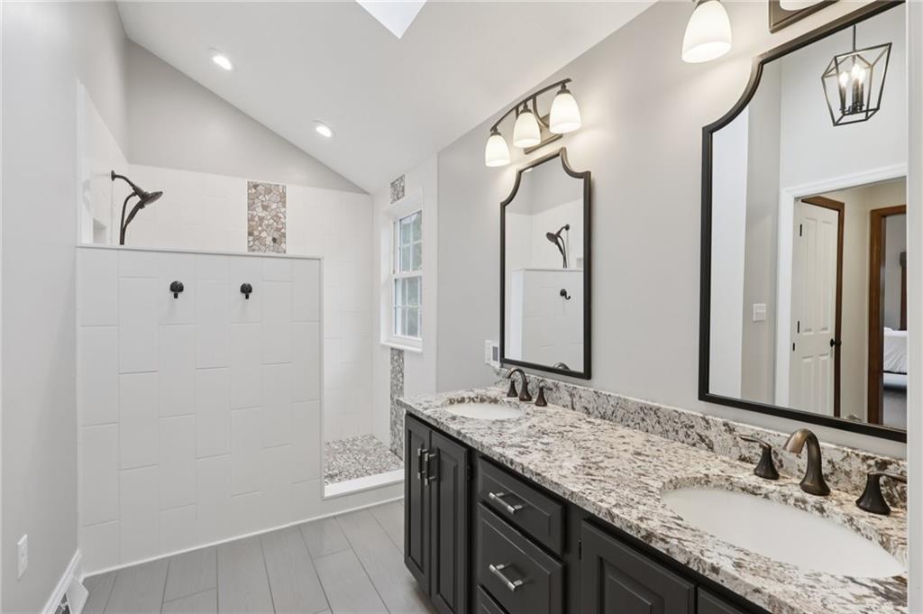 111 American School Road Harmony, PA 16037 - Photo 19 of 46 a bathroom with a granite countertop double vanity sink mirror and