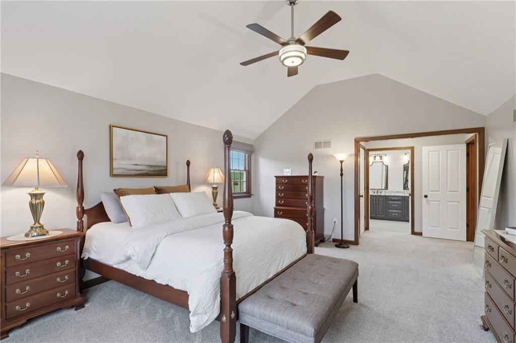 111 American School Road Harmony, PA 16037 - Photo 21 of 46 a spacious bedroom with a bed a ceiling fan and a dresser