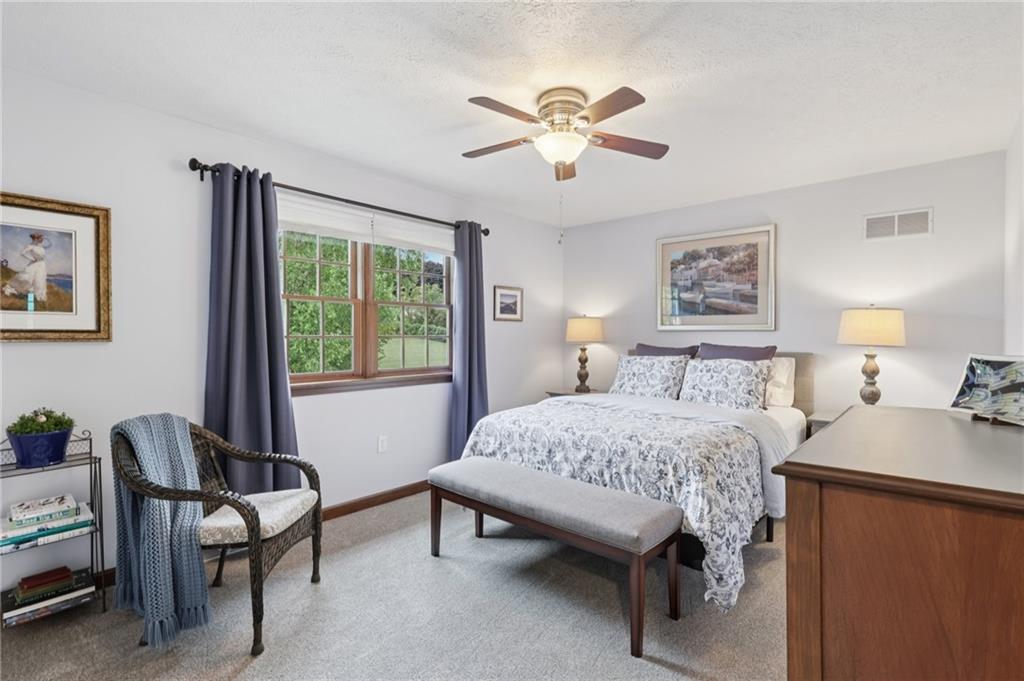 111 American School Road Harmony, PA 16037 - Photo 24 of 46 a bedroom with a bed and a chandelier