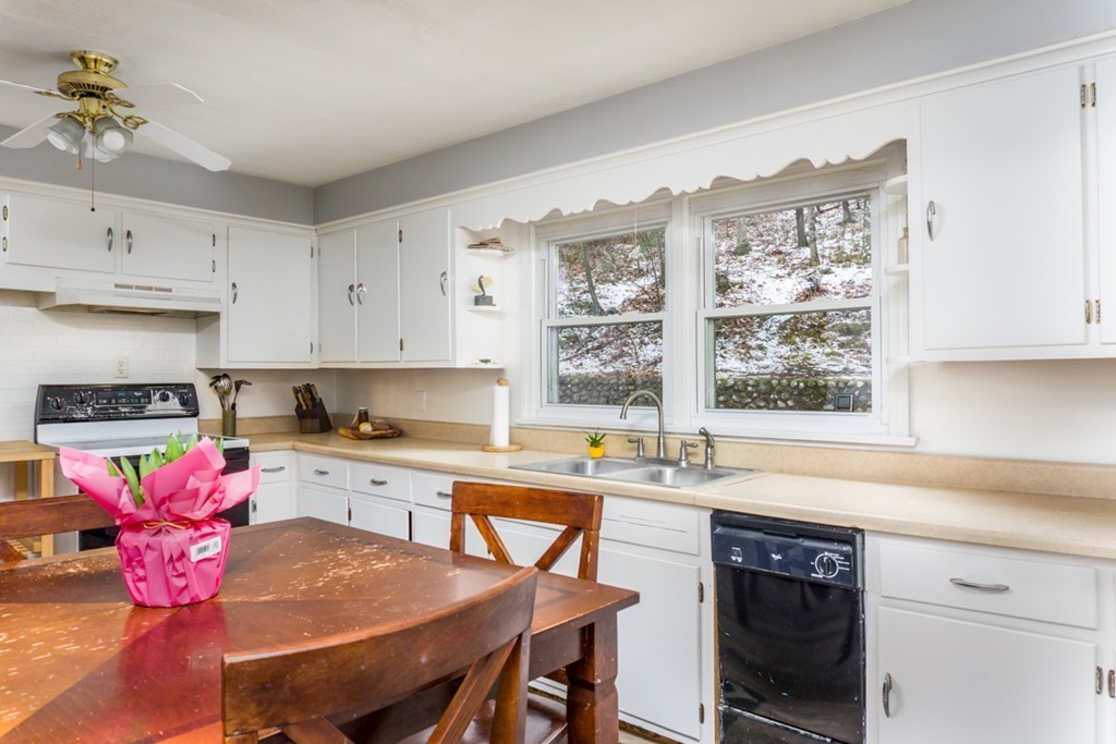 2032 Calkins Road Palmer, MA 01069 - Photo 4 of 23 a kitchen with granite countertop wooden cabinets dining table and chairs