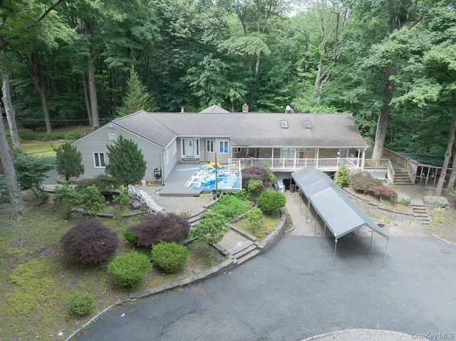 an aerial view of a house with a yard basket ball court and outdoor seating