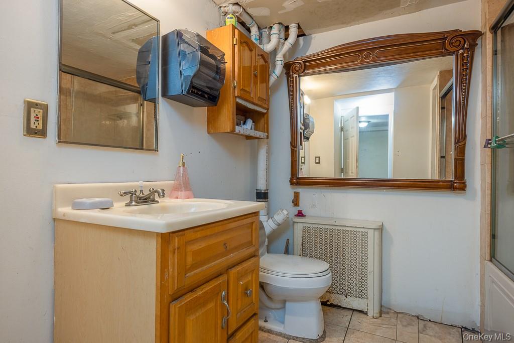 23 Sky Meadow Road Suffern, NY 10901 - Photo 18 of 36 a bathroom with a toilet a sink and mirror