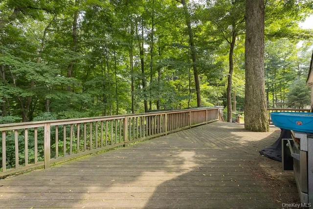 a view of a deck with a large window and wooden floor