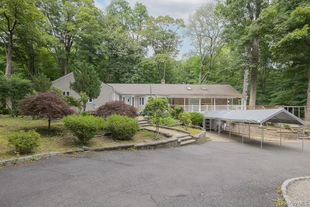 an aerial view of a house with garden space and street view