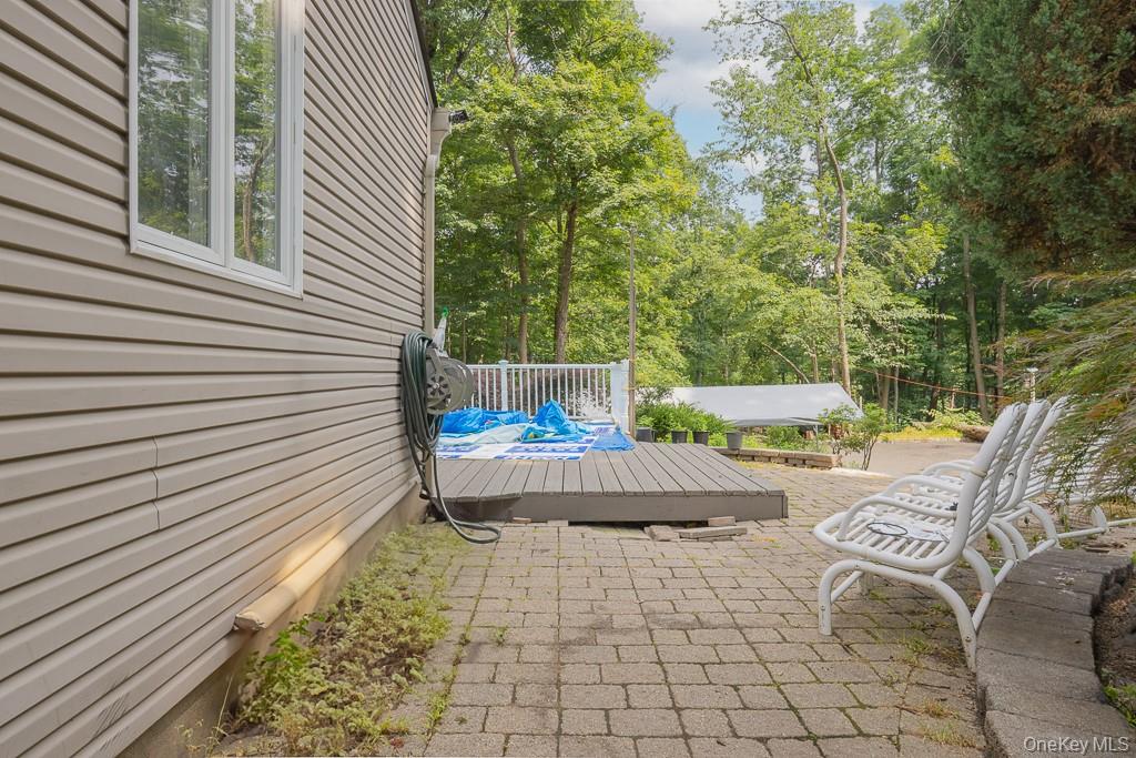 23 Sky Meadow Road Suffern, NY 10901 - Photo 26 of 36 a view of backyard with a table and chairs and potted plants