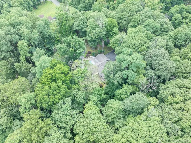 an aerial view of a house with a yard and outdoor seating