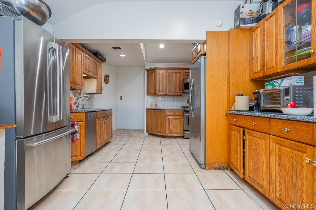 23 Sky Meadow Road Suffern, NY 10901 - Photo 5 of 36 a kitchen with stainless steel appliances granite countertop a refrigerator and a stove top oven