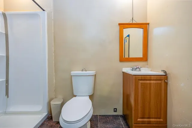 a white toilet sitting next to a bathroom sink