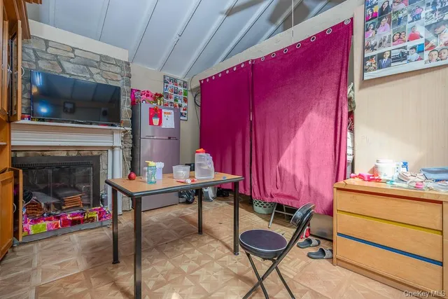 a view of a room with furniture and a fireplace