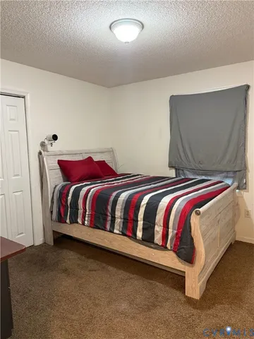 a bed sitting in a bedroom next to a window