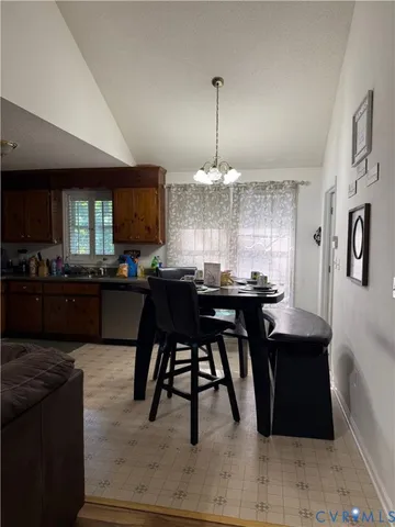 a kitchen with kitchen island granite countertop a sink cabinets and stainless steel appliances