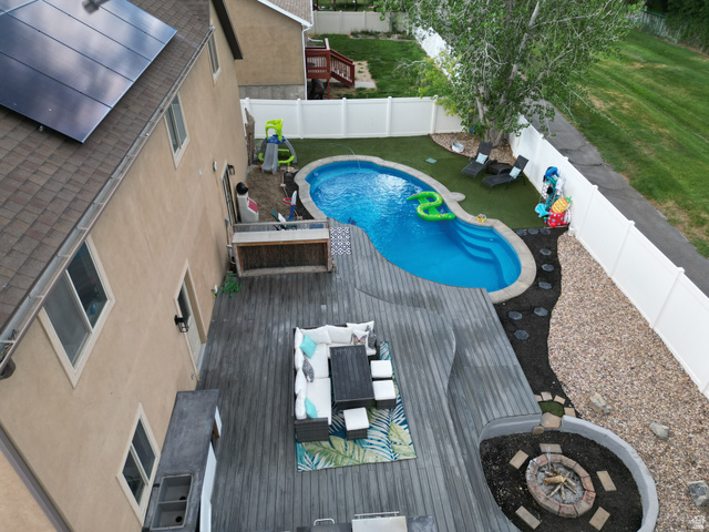 1585 South 910 West Payson, UT 84651 - Photo 28 of 32 Expansive backyard featuring a freeform swimming pool, extensive wood-finish decking, and a built-in fire pit