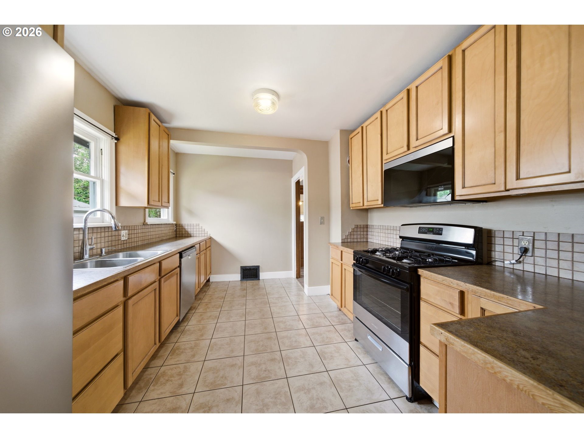 1804 Division Street Camas, WA 98607 - Photo 19 of 43 a kitchen with stainless steel appliances granite countertop a stove a sink and a microwave