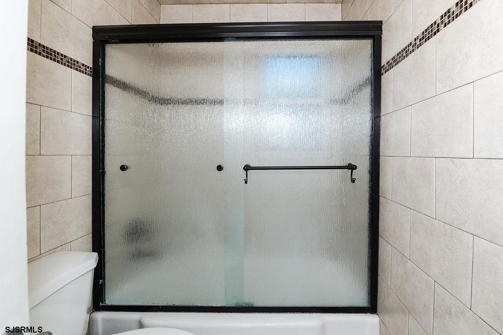 19 South 1st Road Hammonton, NJ 08037 - Photo 16 of 36 a bathroom with a glass shower door