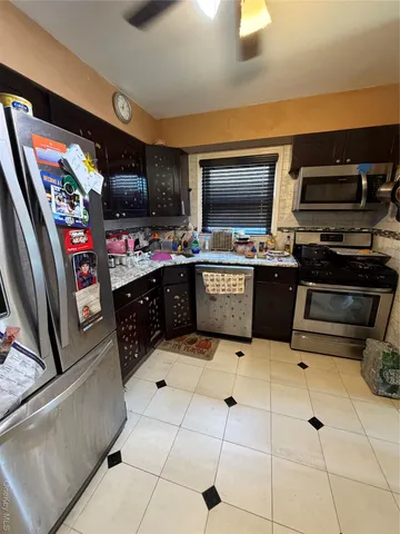 a kitchen with stainless steel appliances a stove a sink and a microwave