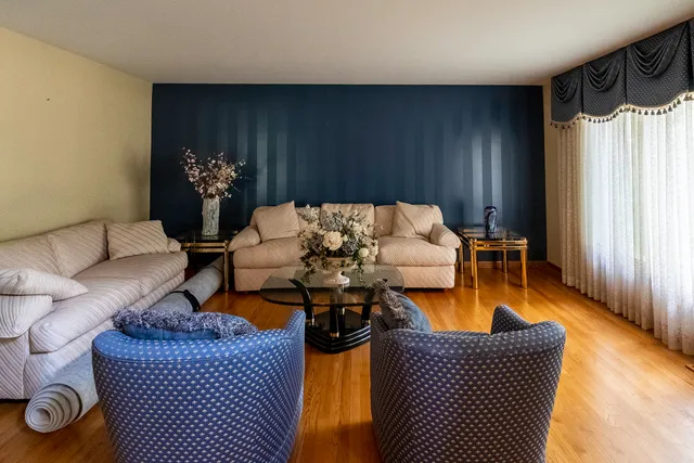 a living room with furniture fireplace and a window