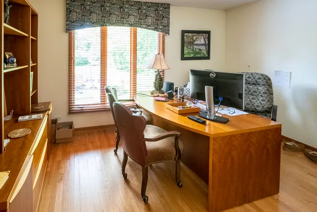 a dining room with furniture and wooden floor