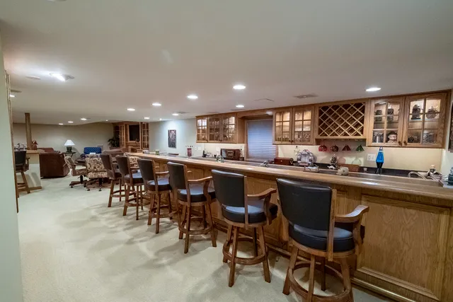 a kitchen with lots of furniture a sink appliances and a dining table