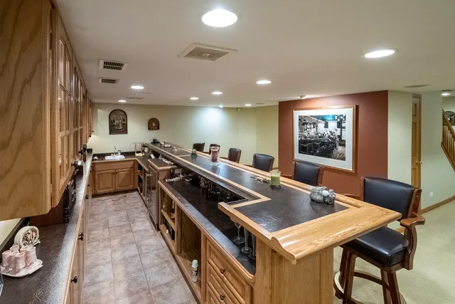 a living room with furniture and a dining table with kitchen view