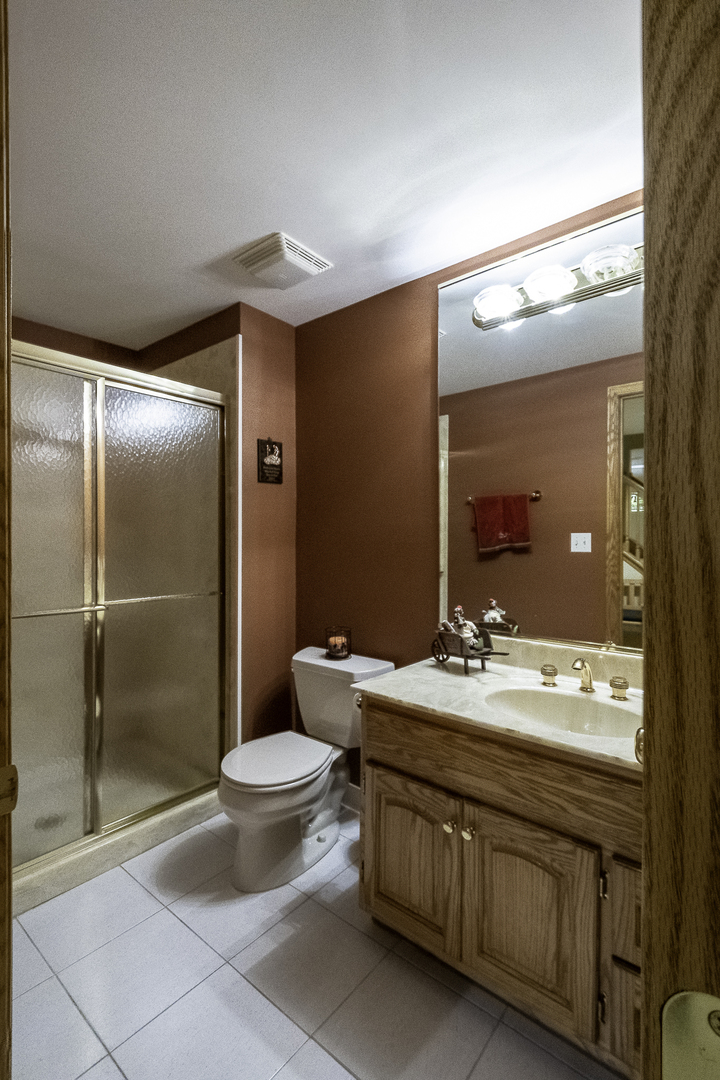4214 Venard Road Downers Grove, IL 60515 - Photo 25 of 45 a bathroom with a granite countertop sink toilet and shower