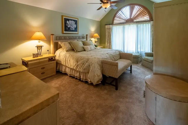 a bathroom with a granite countertop sink and a large mirror