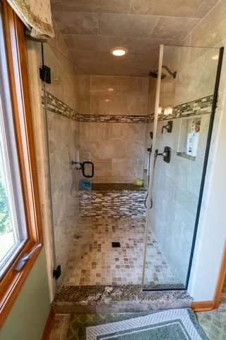 a bathroom with a glass shower door