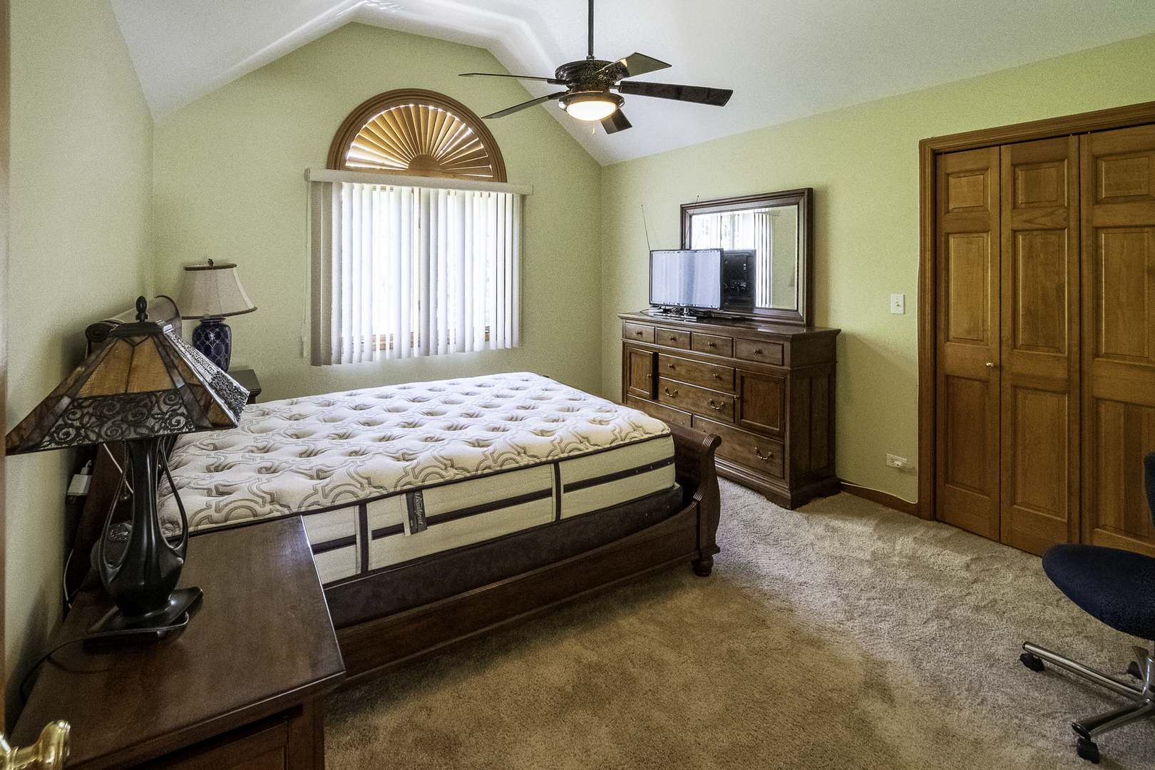 4214 Venard Road Downers Grove, IL 60515 - Photo 32 of 45 a bedroom with a bed and a flat screen tv