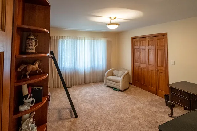 a view of a deck with chairs and a floor to ceiling window with wooden floor