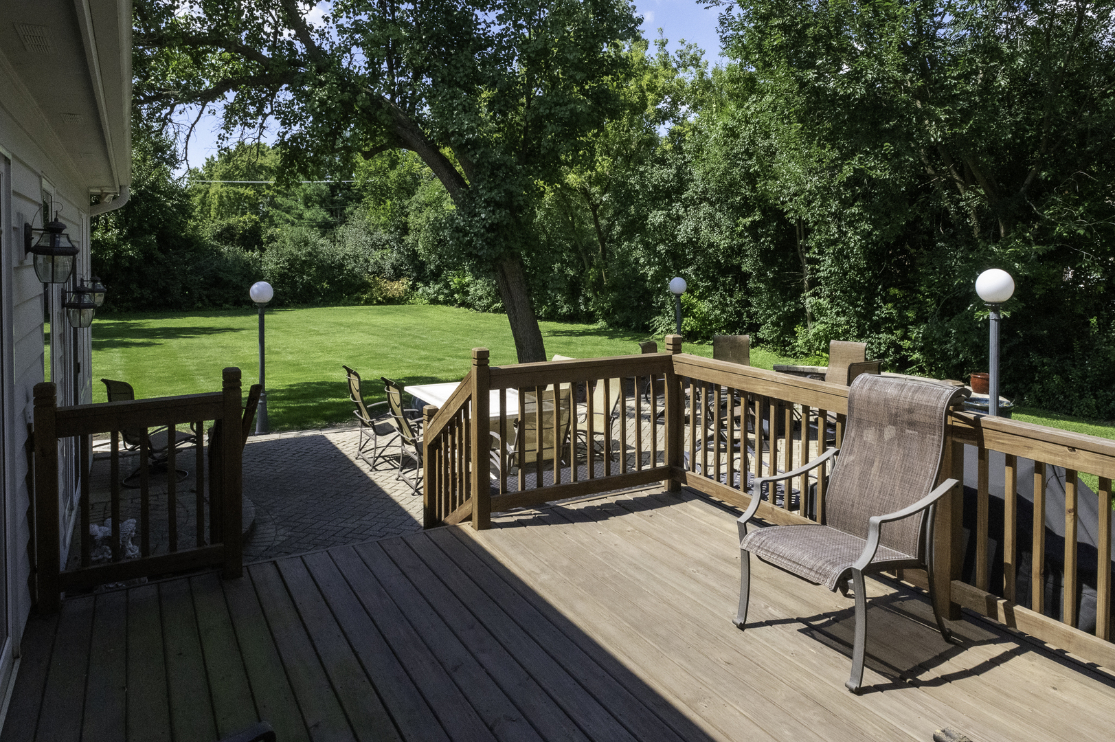 4214 Venard Road Downers Grove, IL 60515 - Photo 37 of 45 a view of a deck with chairs and a floor to ceiling window with wooden floor