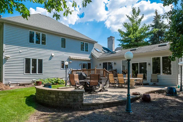 a house view with swimming pool in front of it
