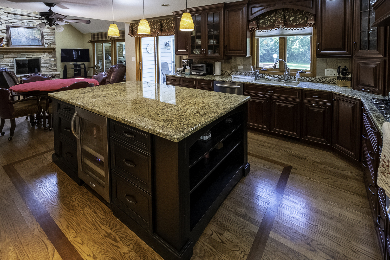 4214 Venard Road Downers Grove, IL 60515 - Photo 4 of 45 a kitchen with stainless steel appliances granite countertop wooden cabinets and wooden floors