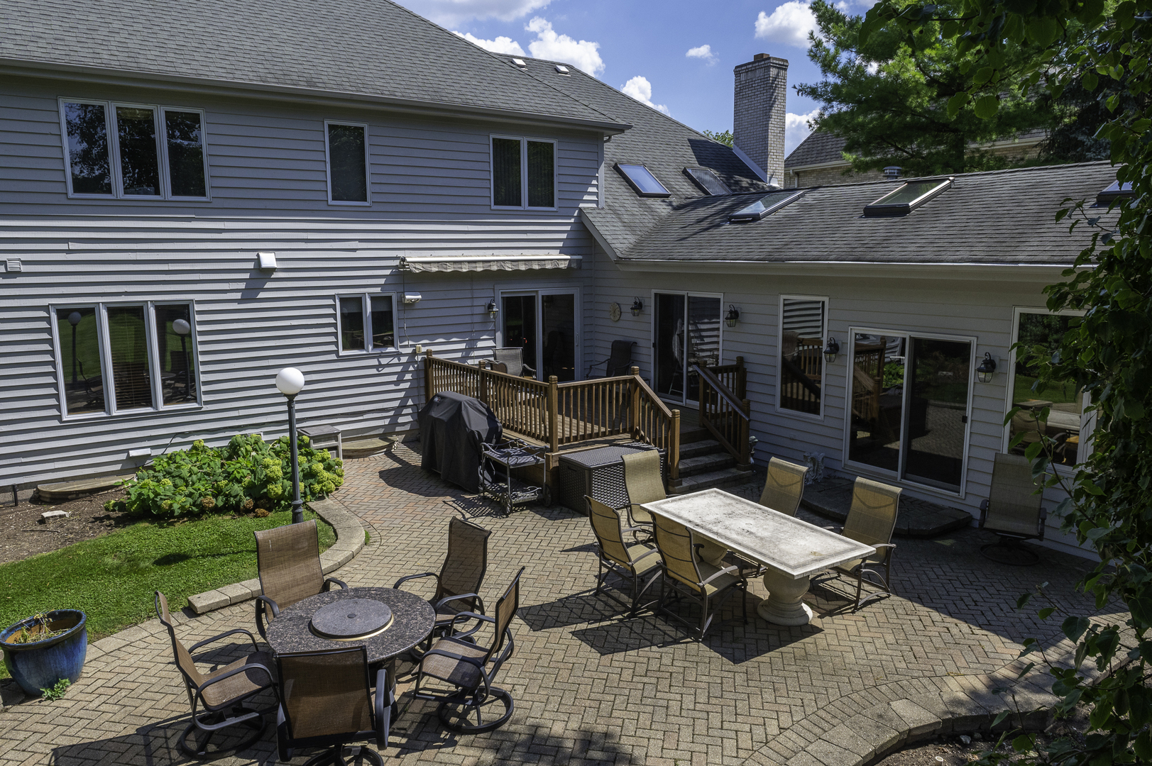 4214 Venard Road Downers Grove, IL 60515 - Photo 44 of 45 a view of a patio with table and chairs potted plants and a large window