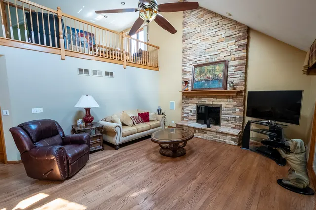 a living room with furniture a flat screen tv and a fireplace