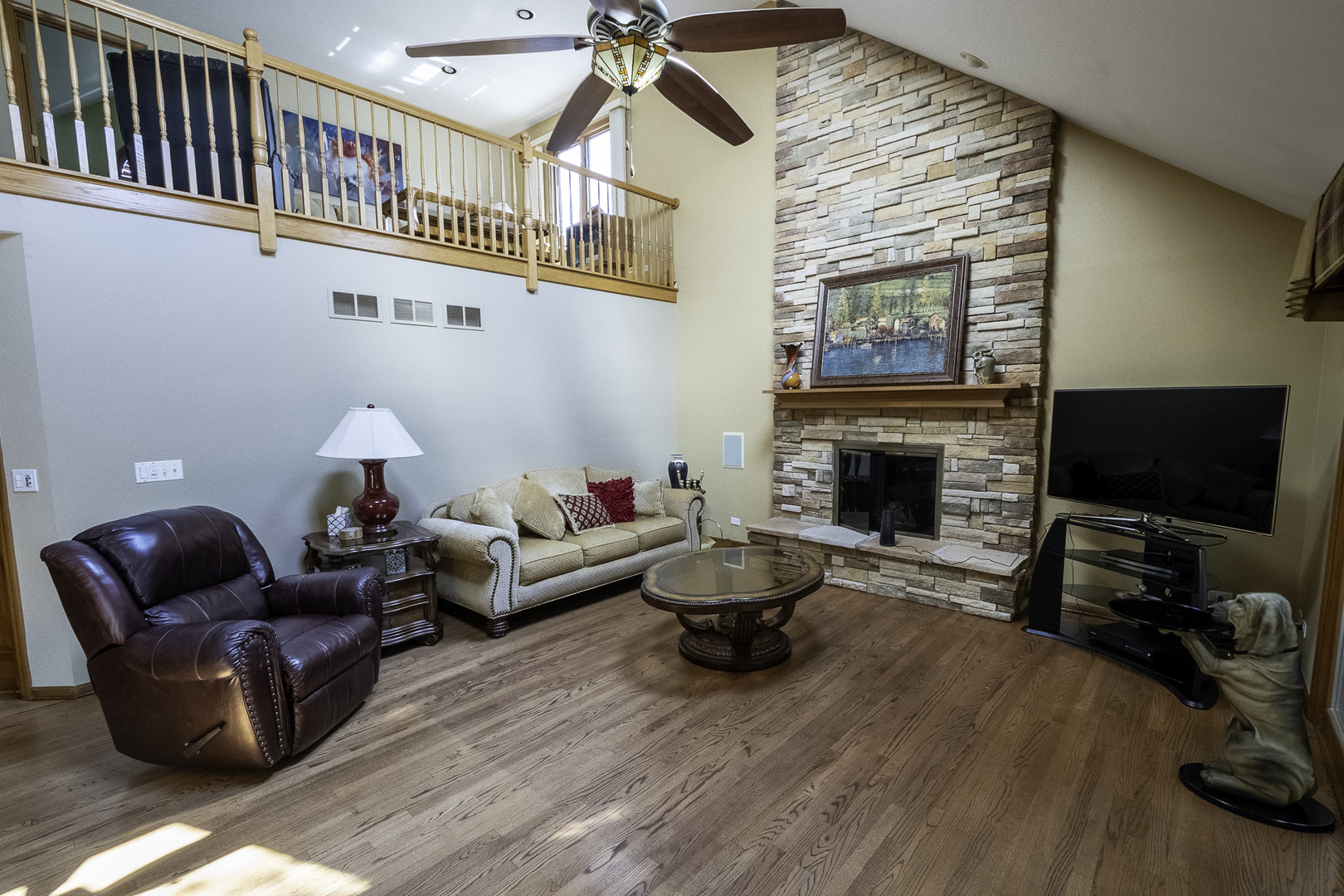 4214 Venard Road Downers Grove, IL 60515 - Photo 8 of 45 a living room with furniture a flat screen tv and a fireplace
