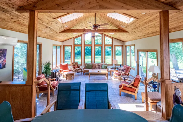 a living room filled with furniture and floor to ceiling windows