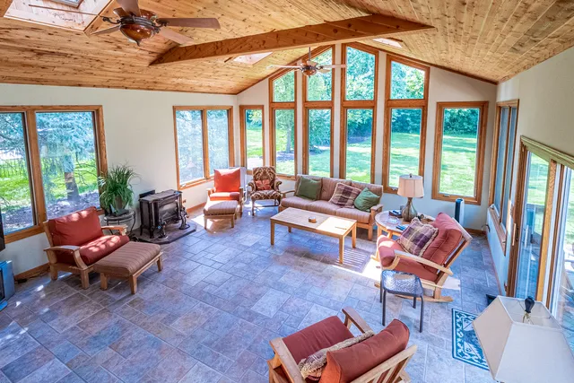 a living room with furniture and floor to ceiling windows
