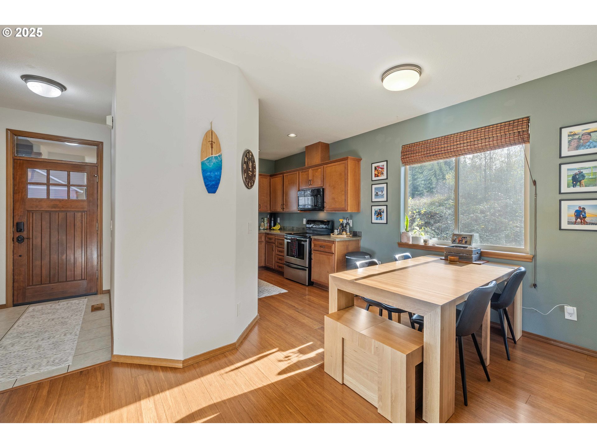 18465 Meadow Avenue Sandy, OR 97055 - Photo 12 of 43 a kitchen with stainless steel appliances granite countertop a refrigerator a stove a sink dishwasher with a dining table and chairs with wooden floor