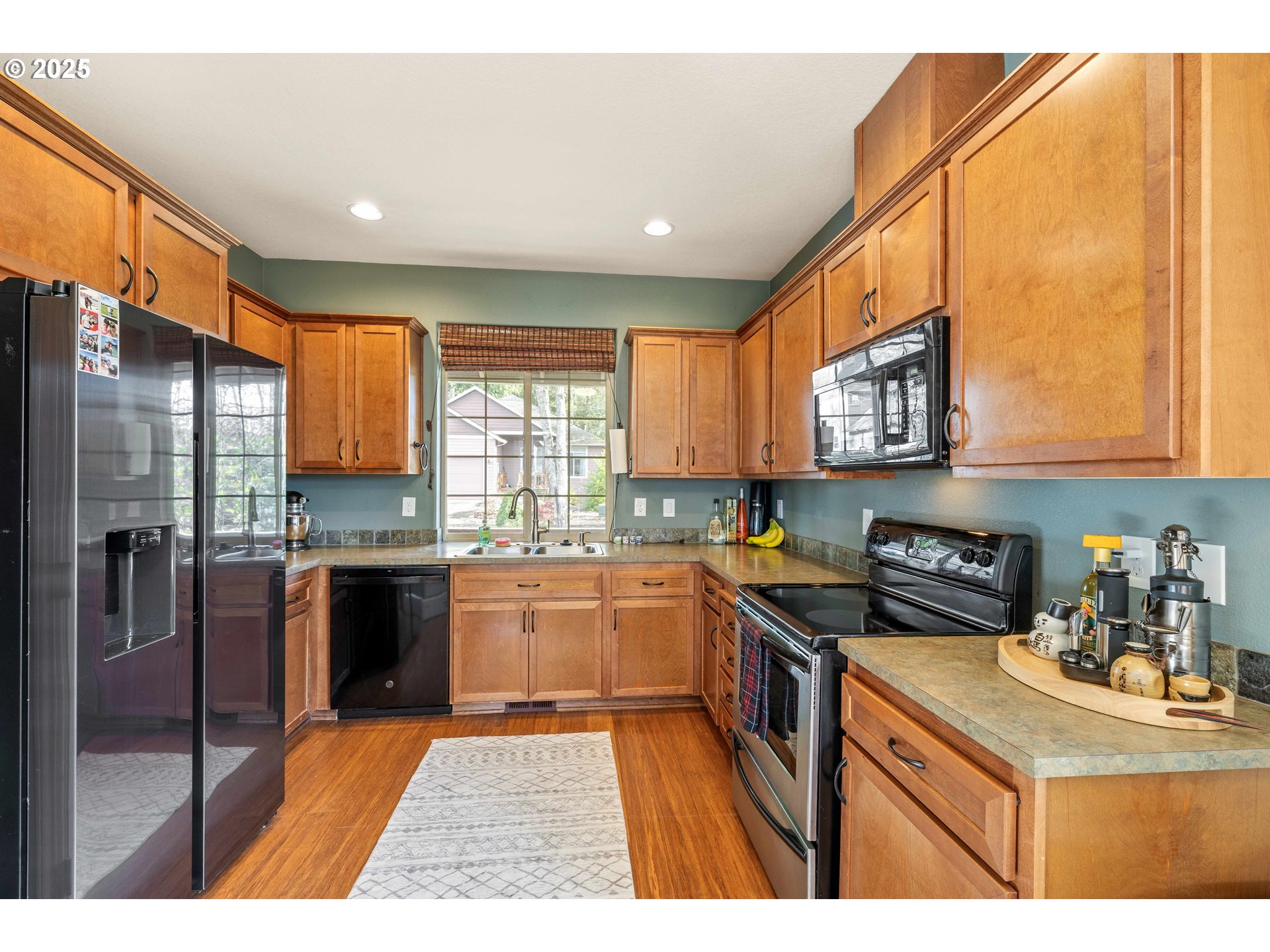 18465 Meadow Avenue Sandy, OR 97055 - Photo 13 of 43 a kitchen with stainless steel appliances granite countertop a sink stove and refrigerator